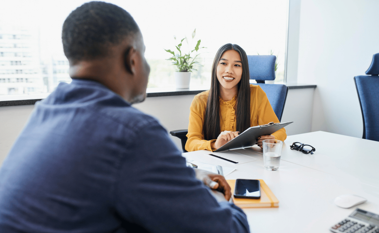 Man and woman having a meeting sitting at a desk